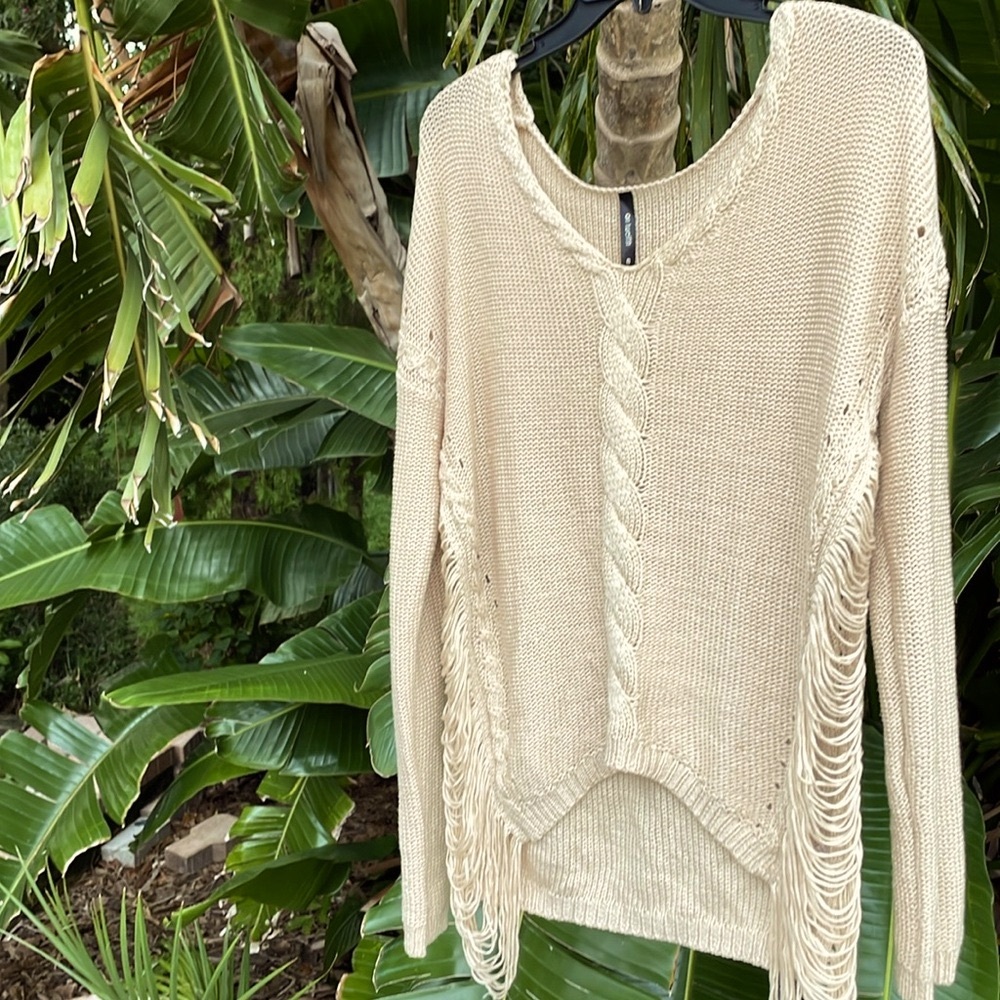 On 12th cable knit and side fringed sweater